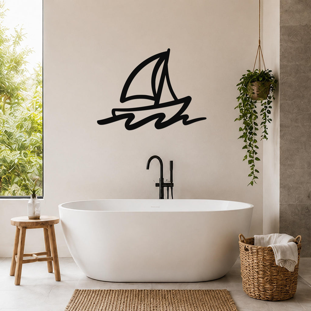 Black metal sailboat wall art with bold lines and wave cutouts, mounted on a bathroom wall above a freestanding tub.