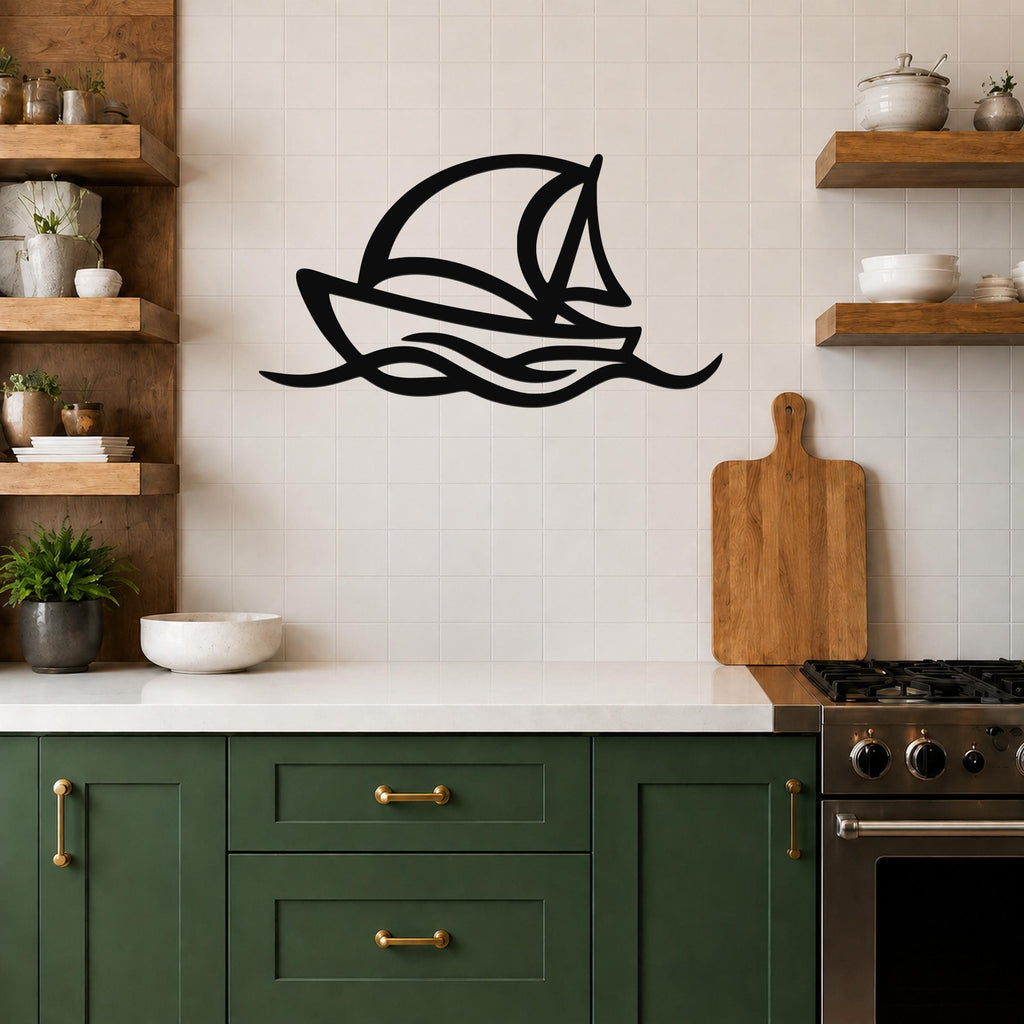 Black metal sailboat wall art with wave cutouts, mounted on a tiled kitchen wall above a counter.