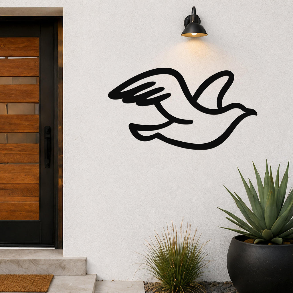 Black metal seagull wall art with motion-line cutouts, mounted on an outdoor wall beside a wooden door and potted plants.