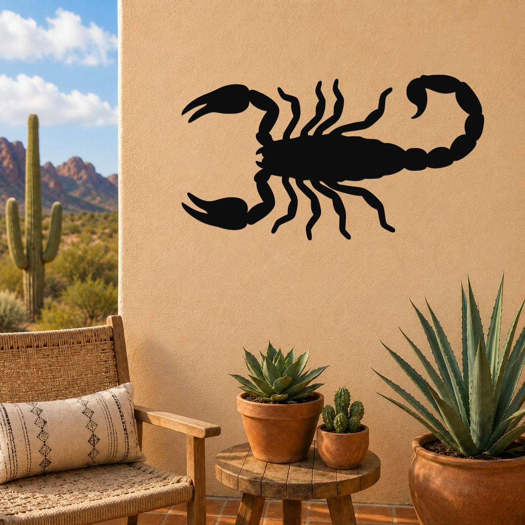 Black metal scorpion wall art silhouette mounted on a tan outdoor wall above a small wooden table with potted succulents and a wicker chair.