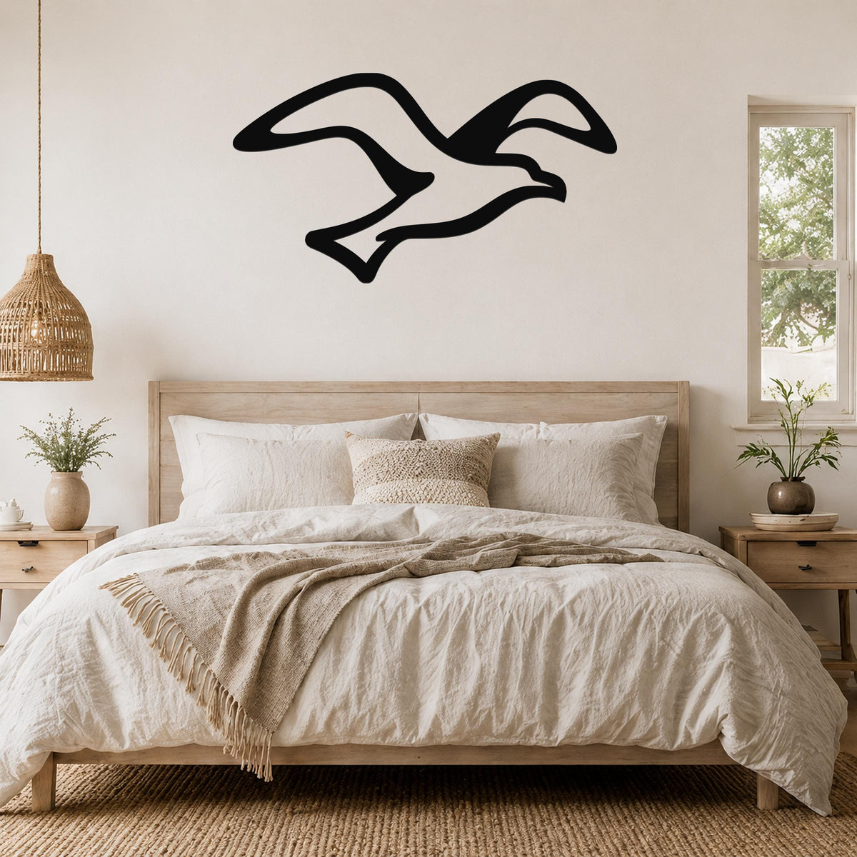 Black metal seagull wall art with flowing motion lines, mounted above a wooden bed in a neutral bedroom.