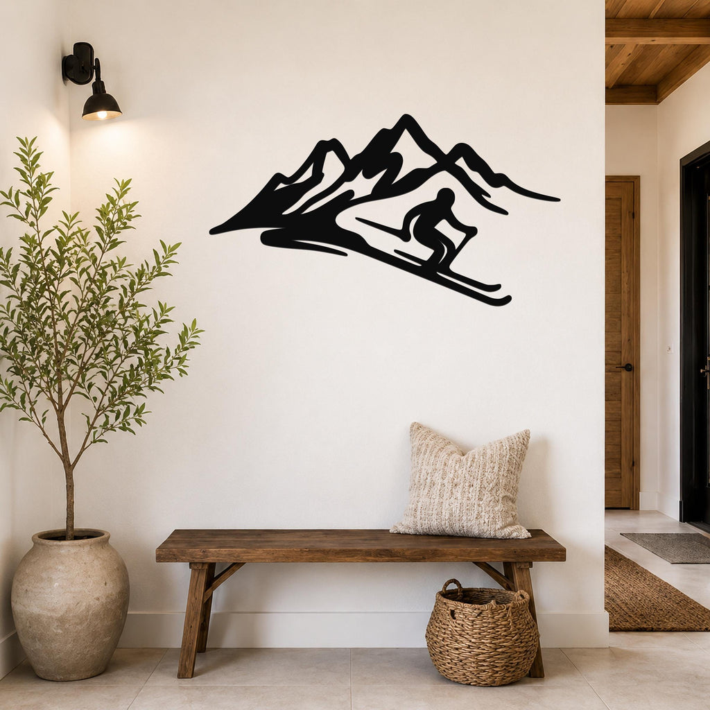 Black metal wall art silhouette of a skier in motion descending a mountain, mounted on a white wall above a wooden bench in a hallway.