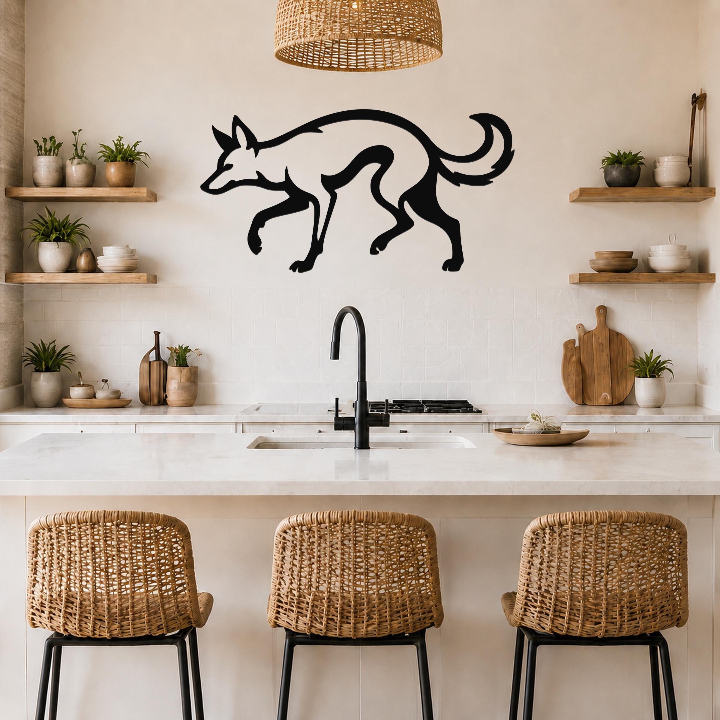 Black metal coyote wall art silhouette with motion-line cutouts, mounted above a kitchen counter in a modern rustic kitchen.