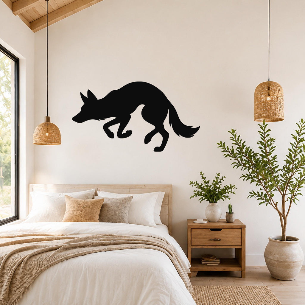 Black metal coyote wall art silhouette mounted above a bed in a bedroom with wooden furniture and woven pendant lights.