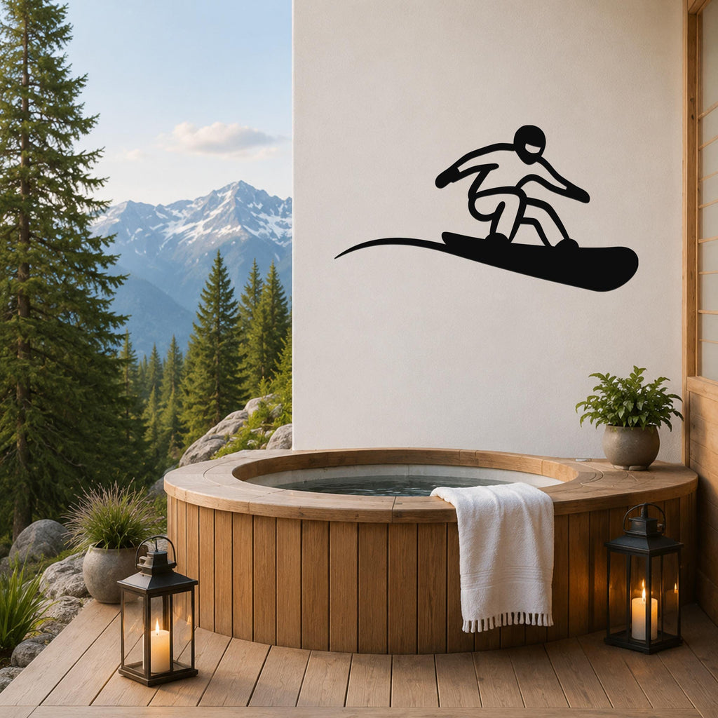 Black metal snowboarder wall art silhouette mounted on a white wall above a wooden hot tub on a mountain-view deck.