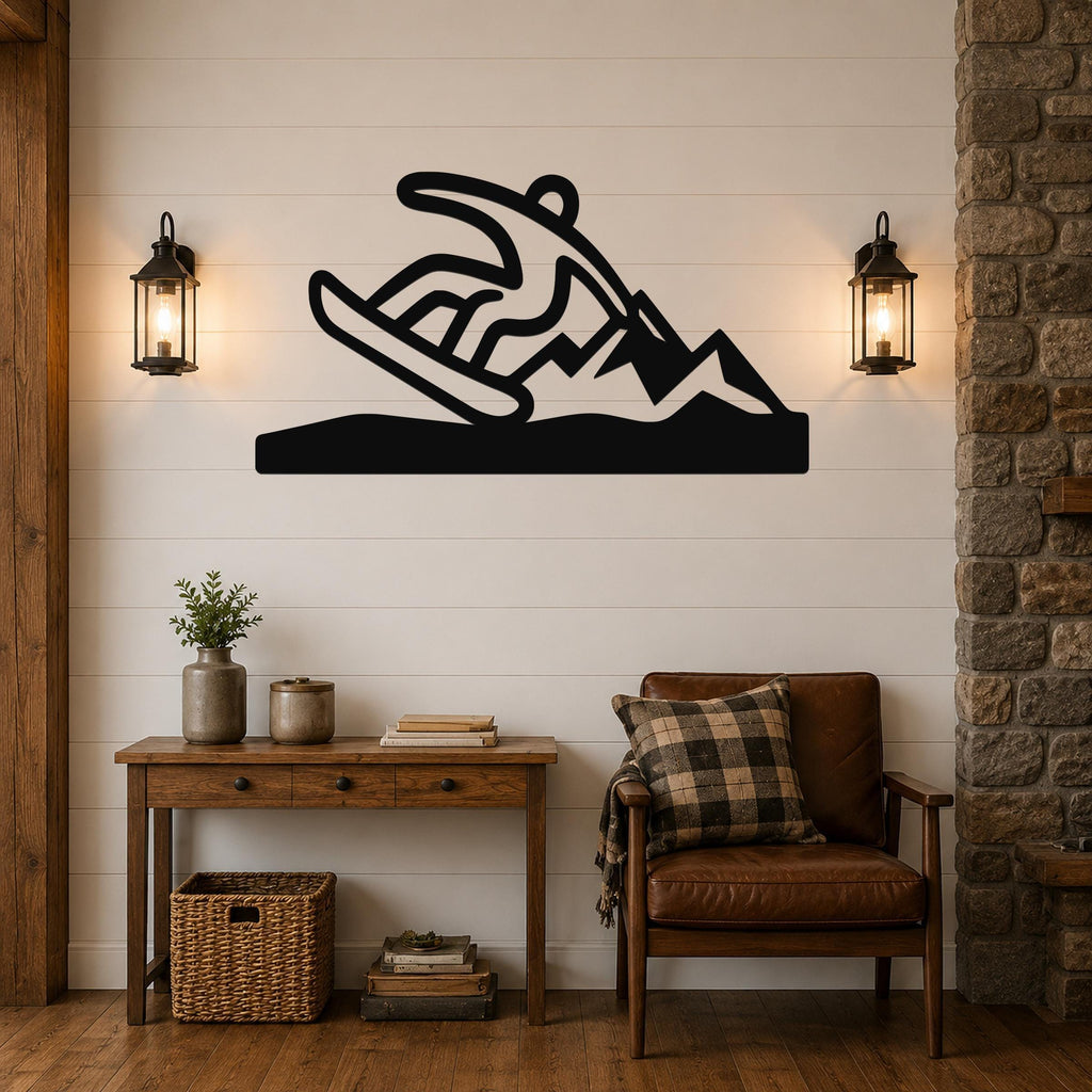 Black metal wall sculpture of a snowboarder in motion, mounted above a wooden console table in a living room with shiplap walls and lanterns.