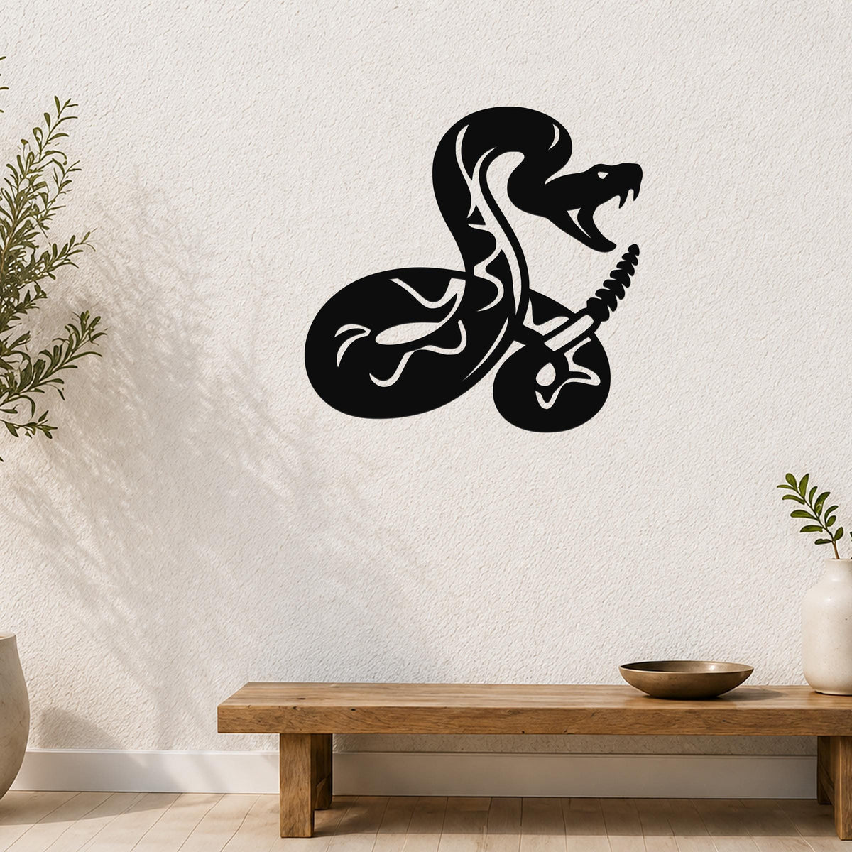 Black metal snake wall art with white internal cutouts, mounted on a textured white wall above a wooden bench in a living room.