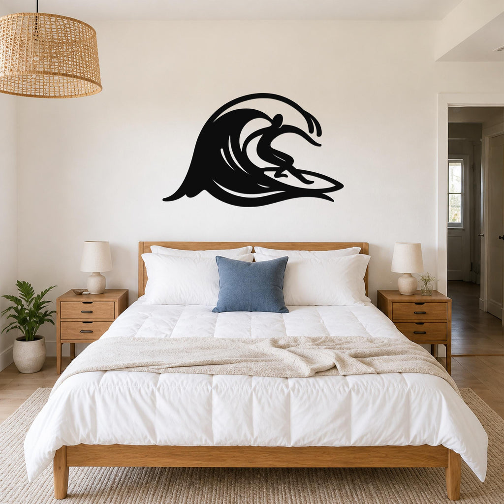 Black metal wall art in a surfer silhouette riding a wave, mounted above a bed in a bedroom.