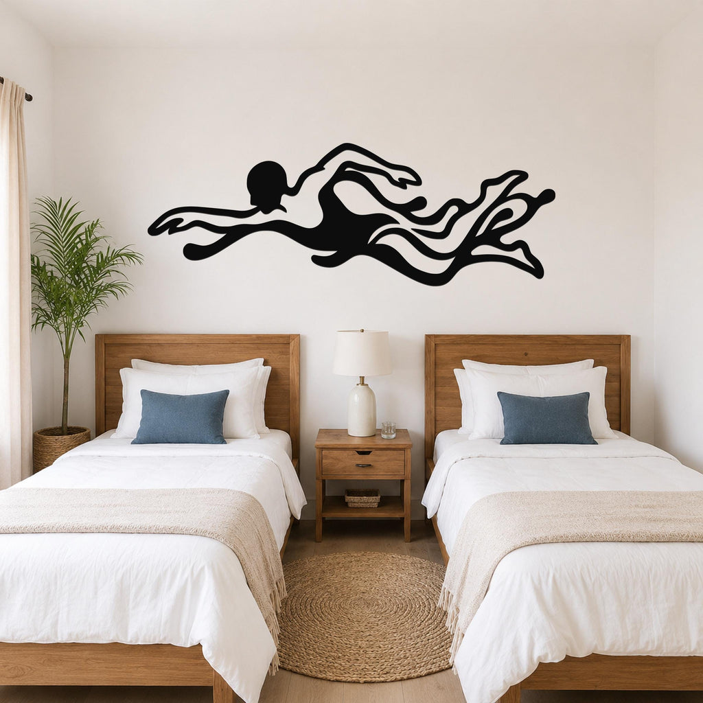 Black metal swimmer wall art with flowing motion cutouts, mounted above two beds in a bedroom.