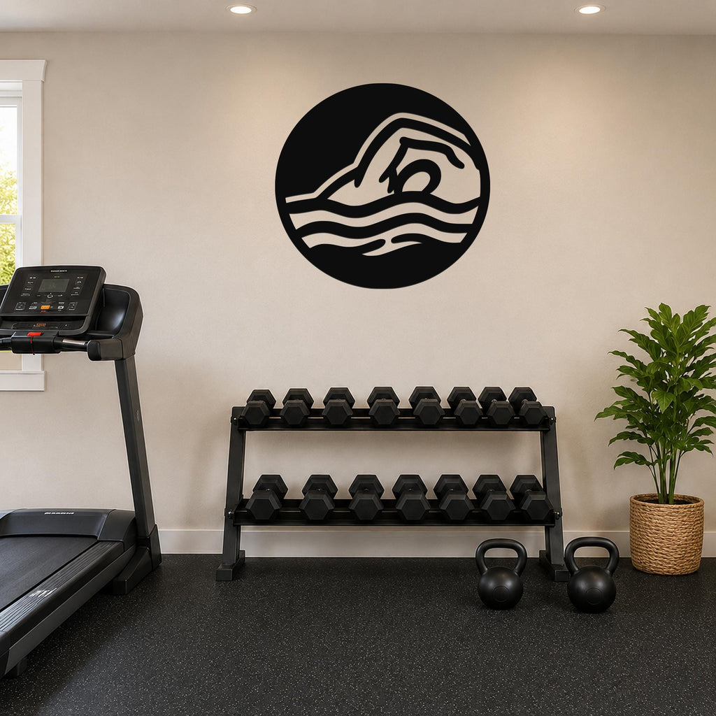 Black metal wall art with a swimmer silhouette and wavy motion lines, mounted on a wall above a dumbbell rack in a home gym.