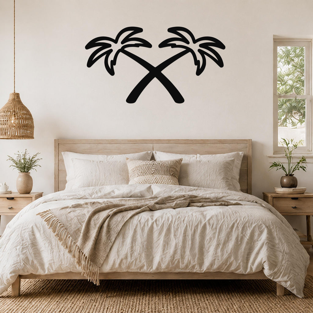Black metal wall art featuring two crossed palm trees in silhouette, mounted above a wooden bed in a neutral-toned bedroom.