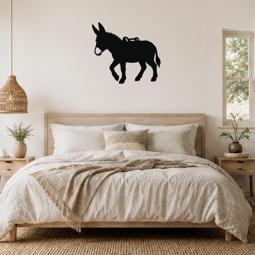 Black metal burro silhouette wall art mounted above a wooden bed in a neutral bedroom.