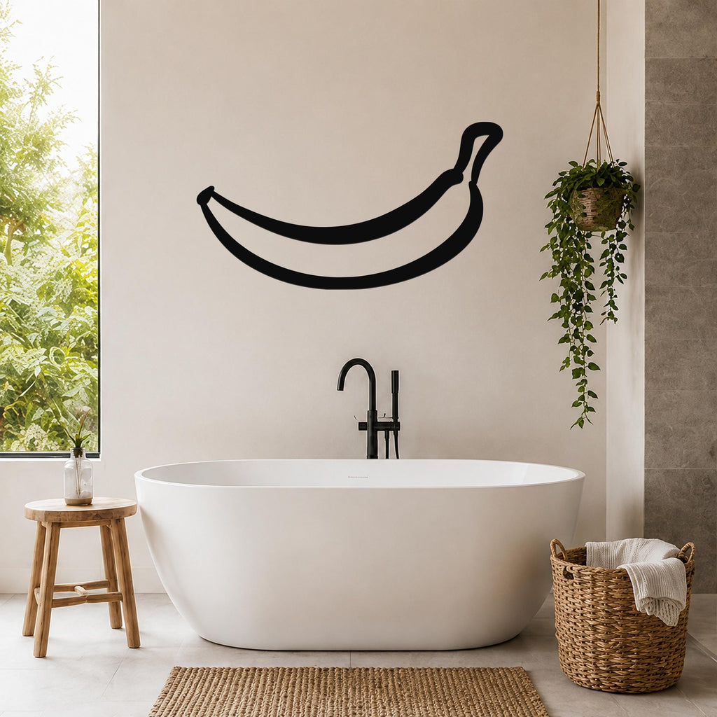 Black metal banana wall art silhouette mounted on a bathroom wall above a freestanding tub.