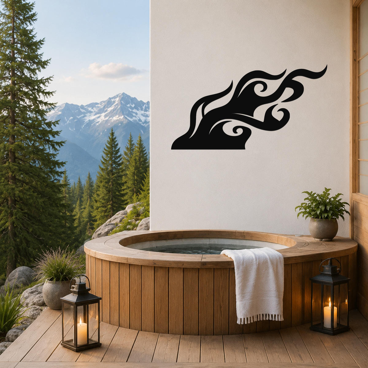 Black metal flame wall art with flowing silhouette cutouts, mounted on a white wall above a wooden hot tub on a mountain-view deck.