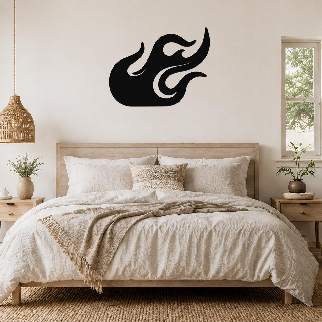 Black metal flame wall art with flowing cutout design, mounted above a wooden bed in a neutral bedroom.