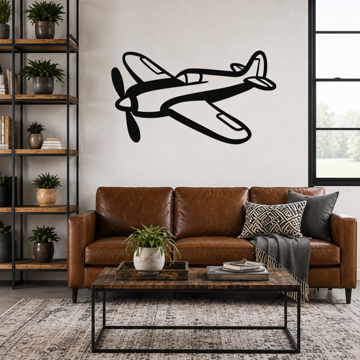 Black metal airplane wall art with a bold silhouette design, mounted above a brown leather sofa in a living room.