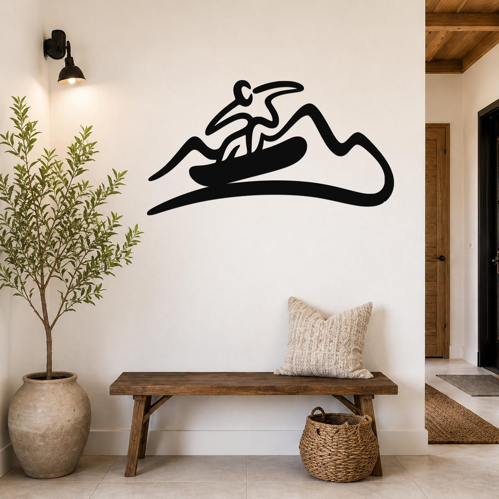 Black metal wall art silhouette of a snowboarder on a mountain, mounted above a wooden bench in a hallway.