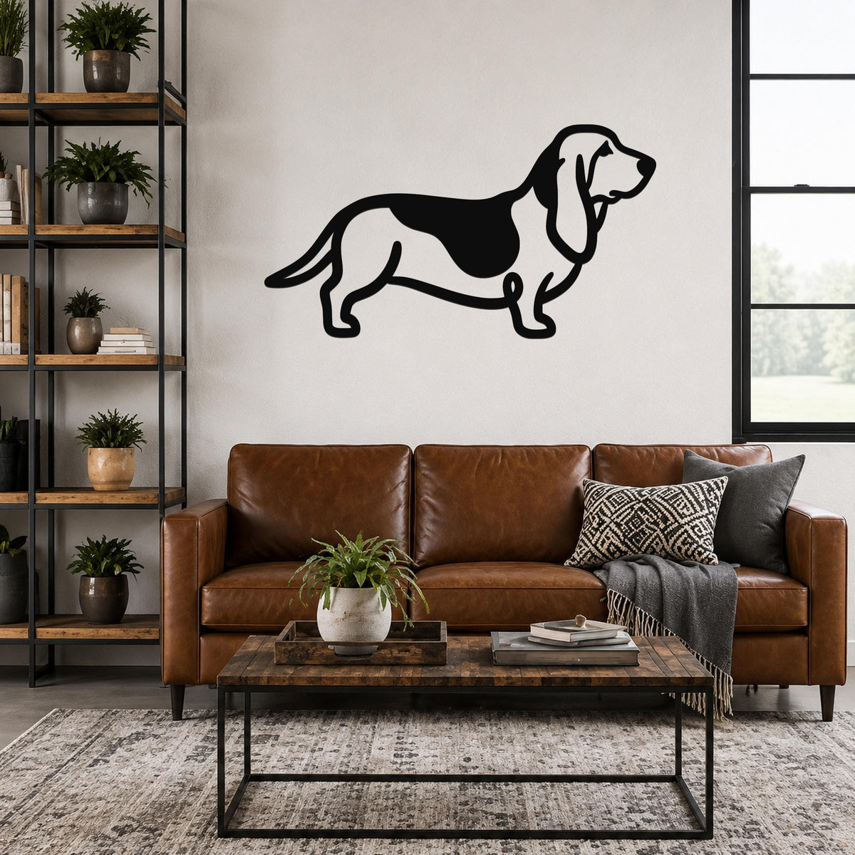 Black metal Basset Hound silhouette wall art mounted on a living room wall above a brown leather sofa.