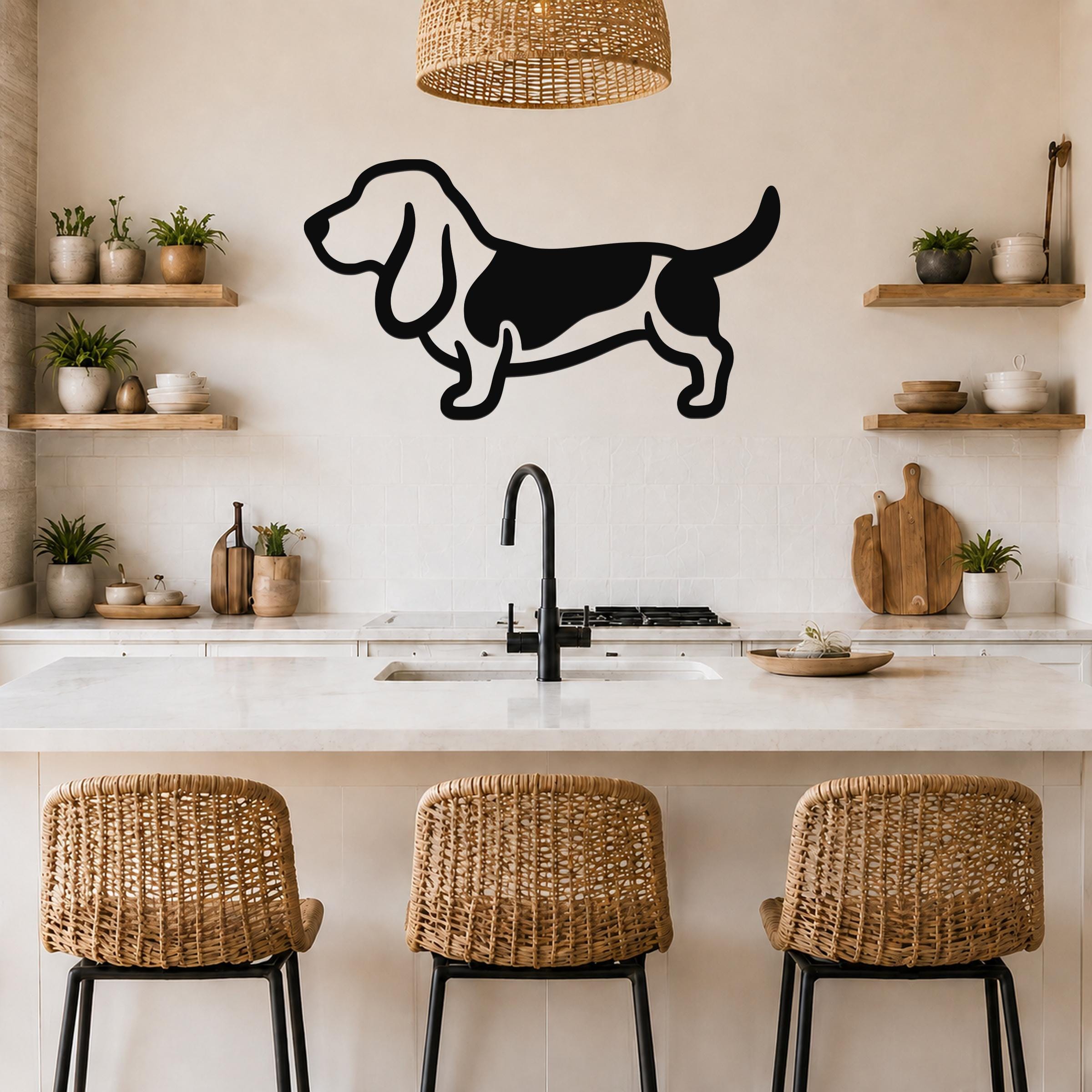 Black metal Basset Hound silhouette wall art mounted on a kitchen wall above a counter, with a wicker pendant light and wooden shelves visible.
