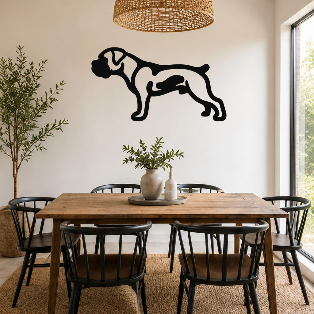 Black metal Boxer dog wall art with internal cutout details, mounted on a white wall above a wooden dining table in a bright dining room.