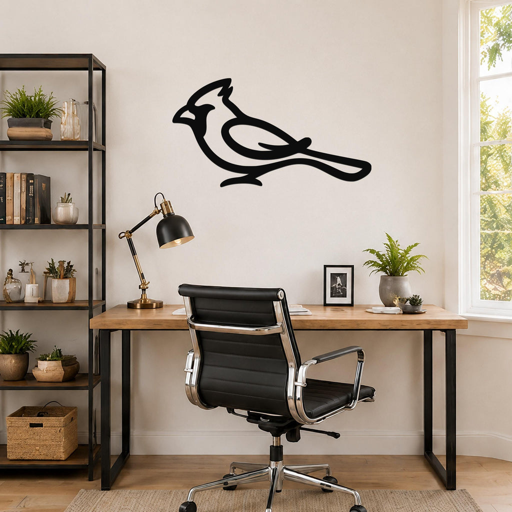 Black metal cardinal wall art with a bold silhouette design, mounted on a wall above a wooden desk in a home office.