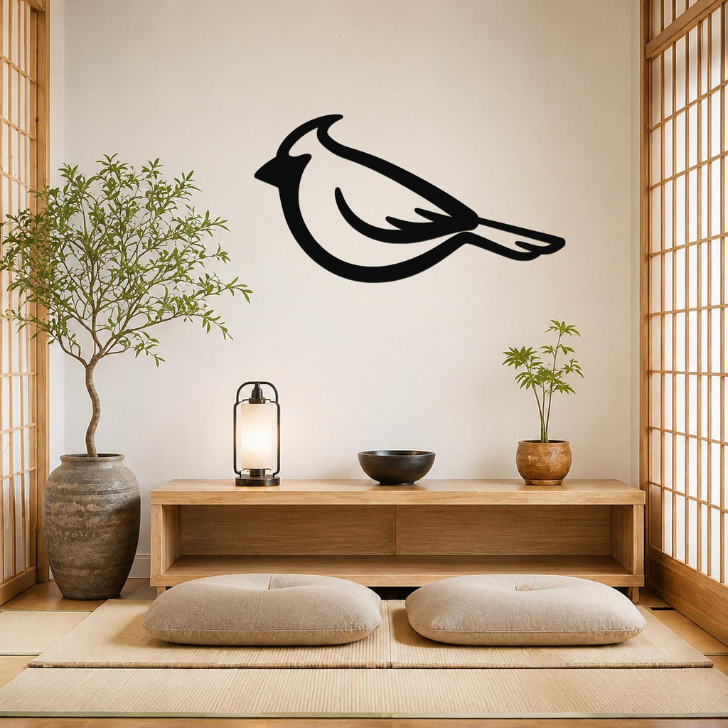 Black metal cardinal wall art silhouette mounted on a light-colored wall above a wooden console in a minimalist room with tatami mats and shoji screens.