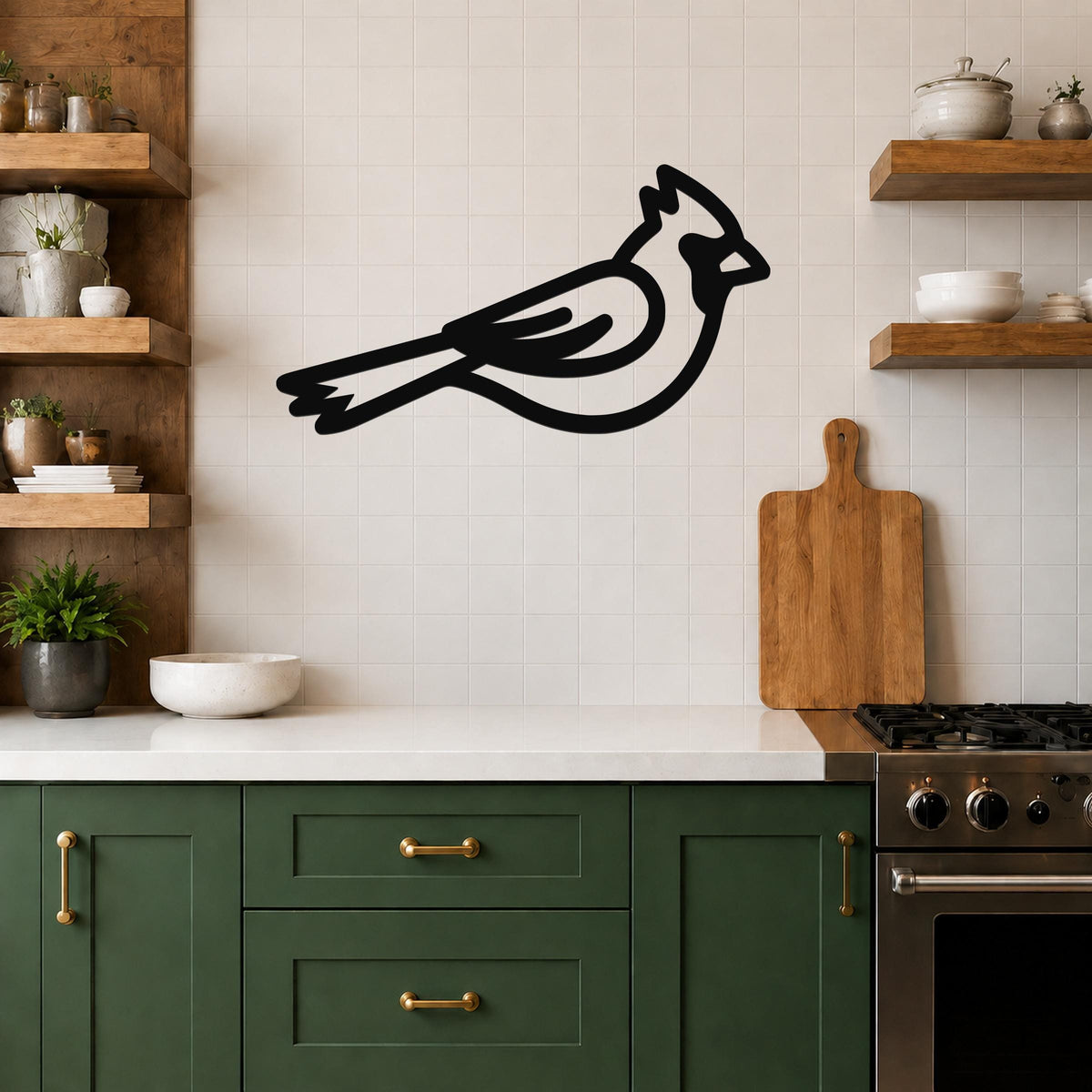 Black metal cardinal wall art silhouette mounted on a tiled kitchen wall above a counter, with wooden shelves and green cabinets visible.