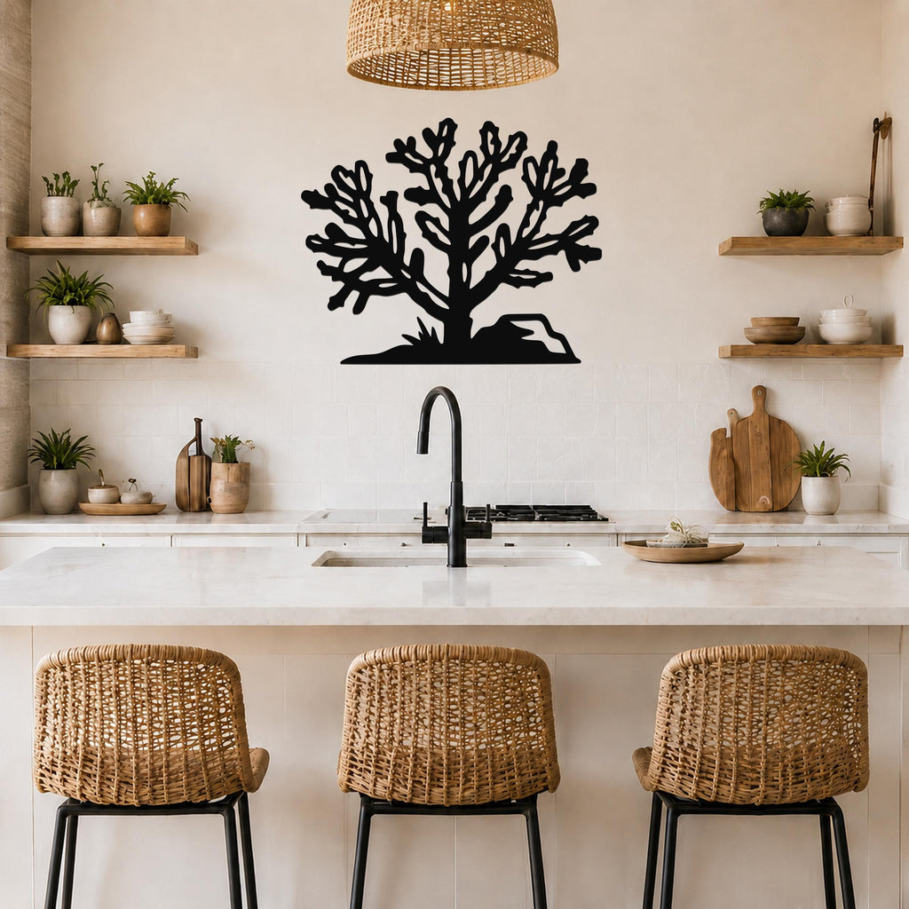 Black metal Cholla cactus wall art with intricate branch cutouts, mounted on a kitchen wall above a counter.