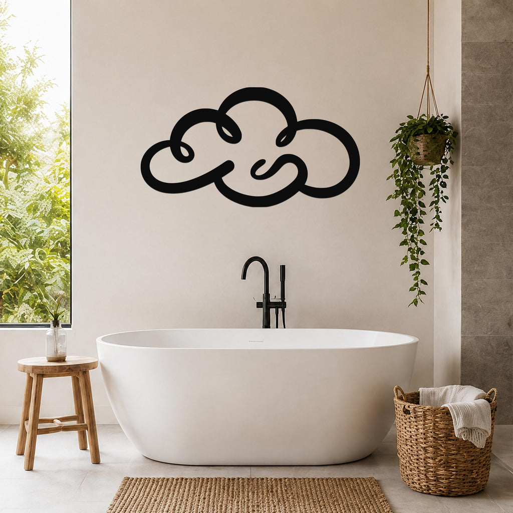 Black metal cloud wall art with flowing silhouette design, mounted on a bathroom wall above a freestanding tub.