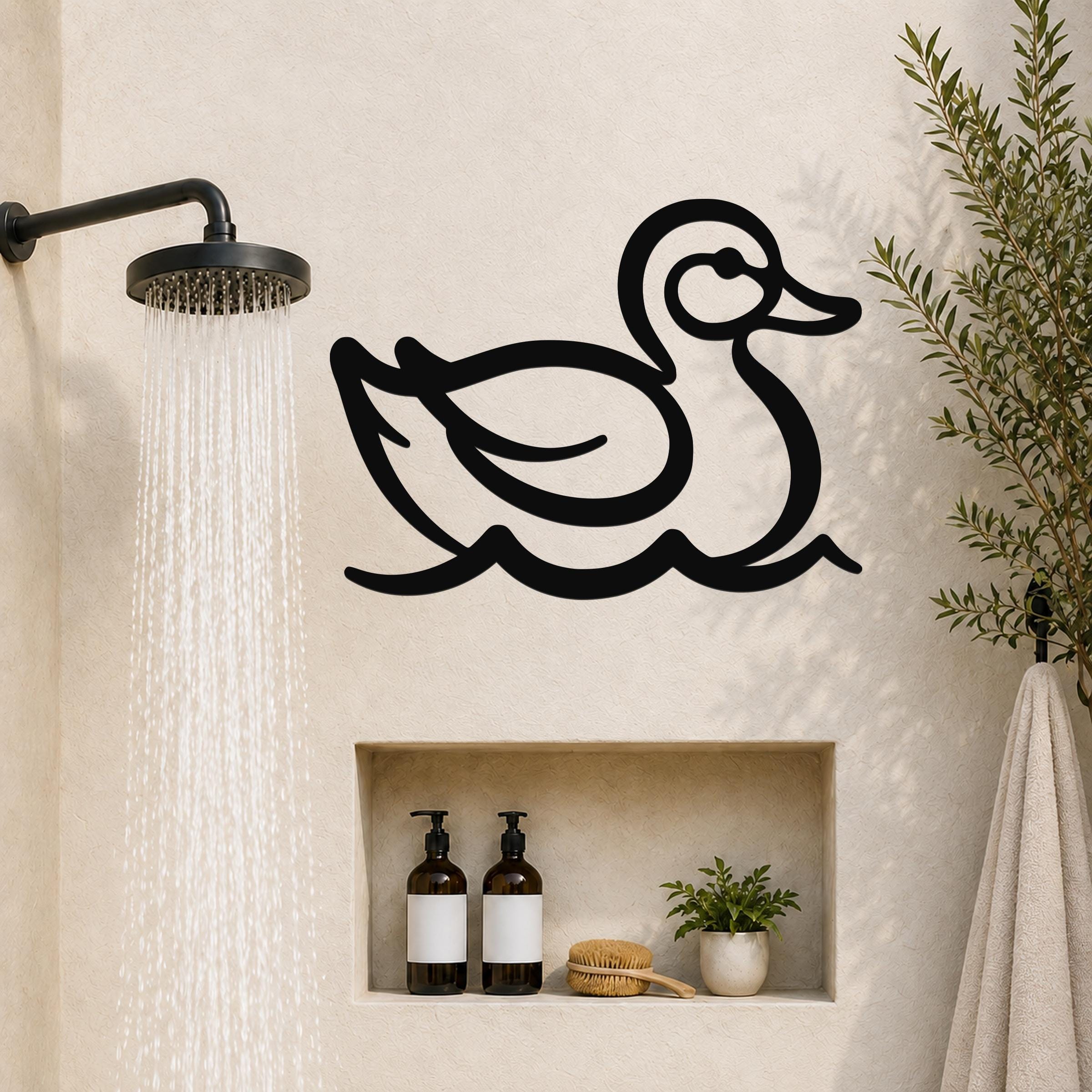 Black metal duck wall art silhouette with water wave cutouts, mounted on a bathroom wall above a built-in shelf.