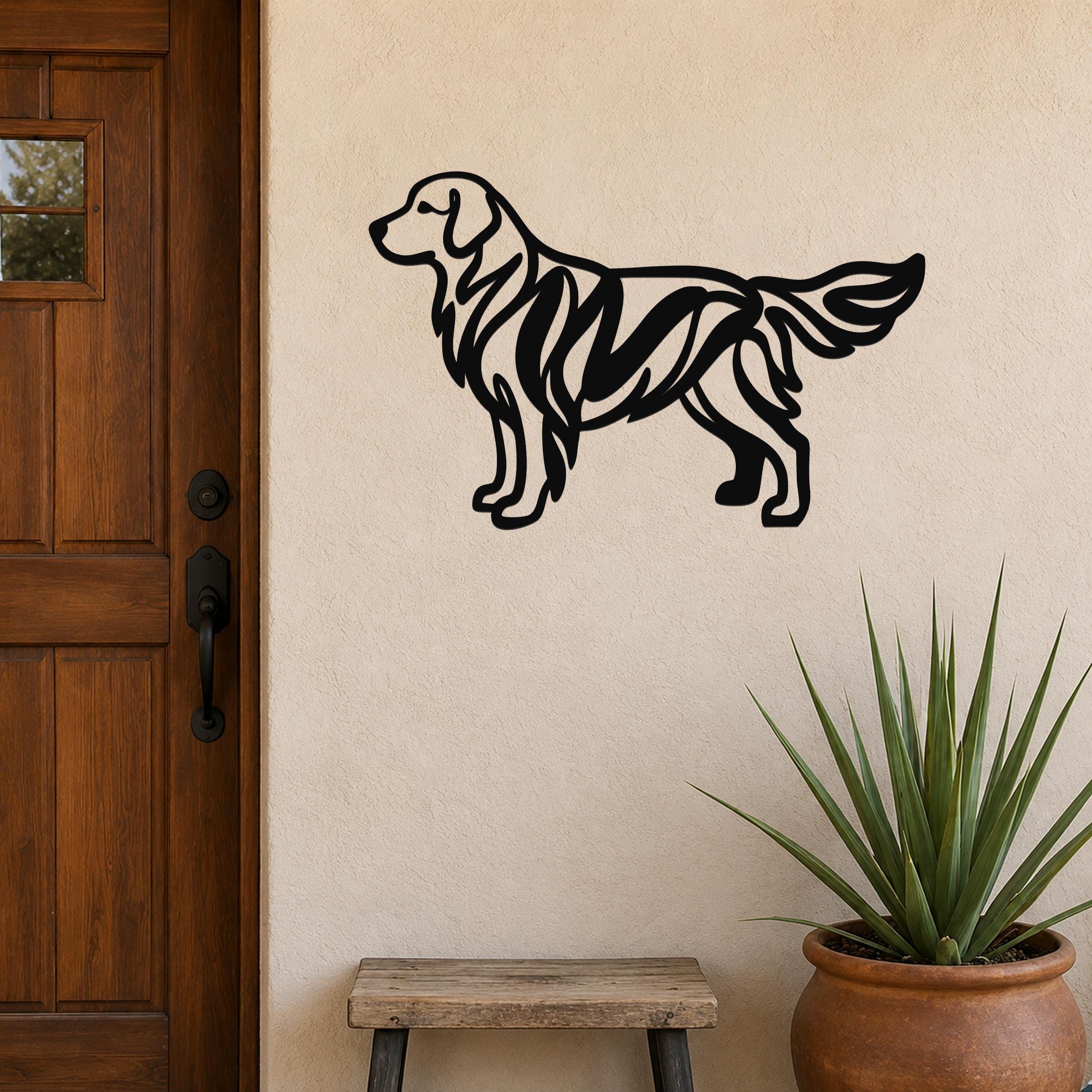 Black metal Golden Retriever wall art with internal cutout details, mounted on a beige exterior wall beside a wooden door and a potted plant.