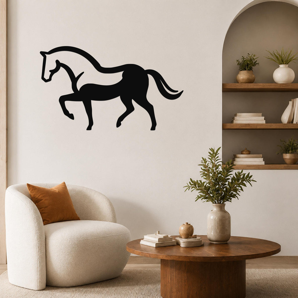 Black metal horse wall art silhouette with internal cutout details, mounted on a living room wall above a white armchair.