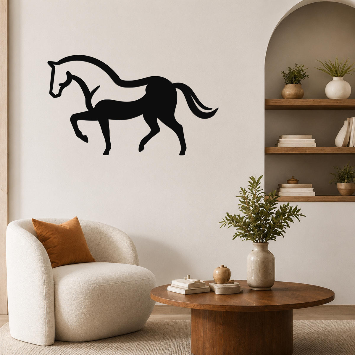 Black metal horse wall art silhouette with internal cutout details, mounted on a living room wall above a white armchair.