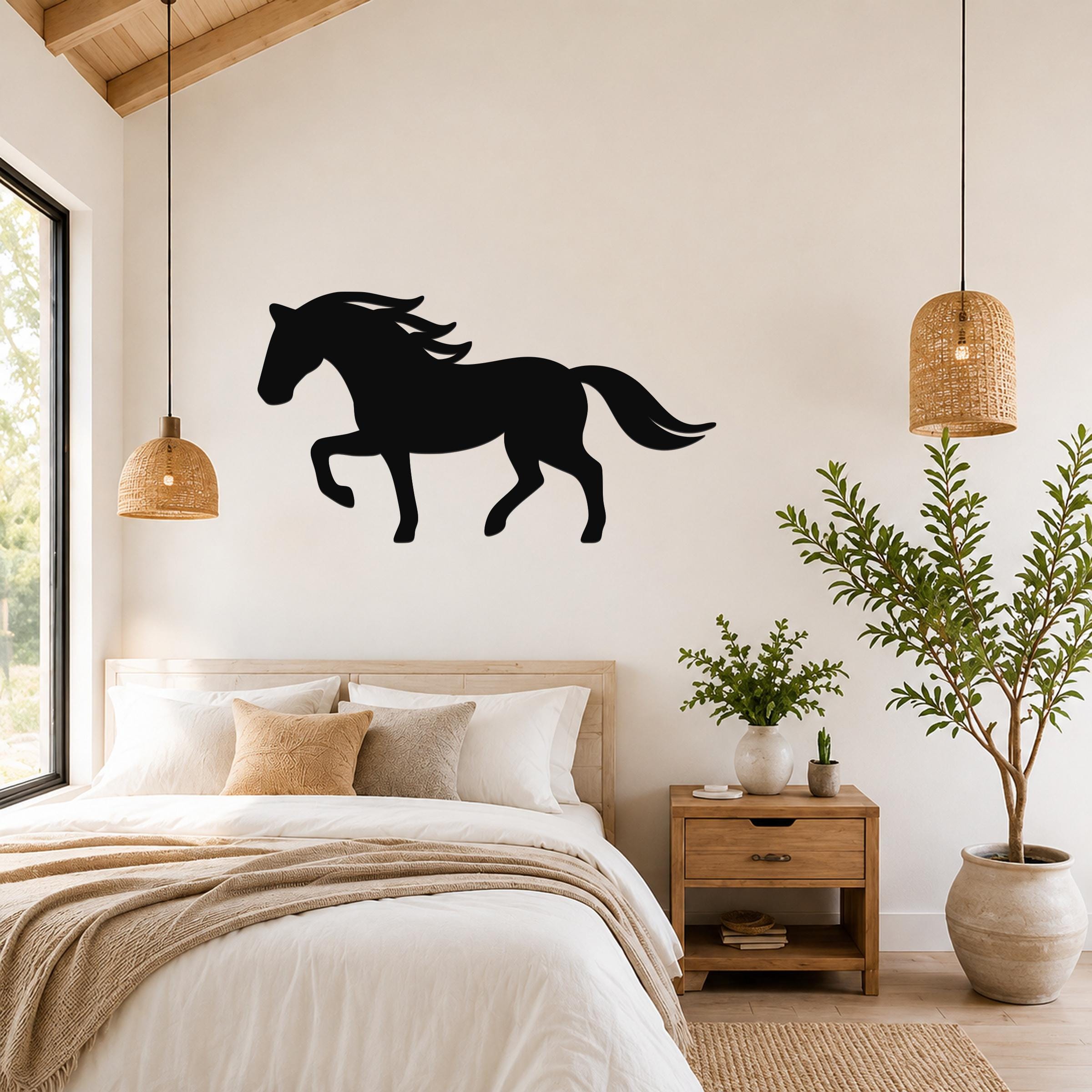 Black metal horse silhouette wall art with flowing mane and tail, mounted above a bed in a rustic bedroom.