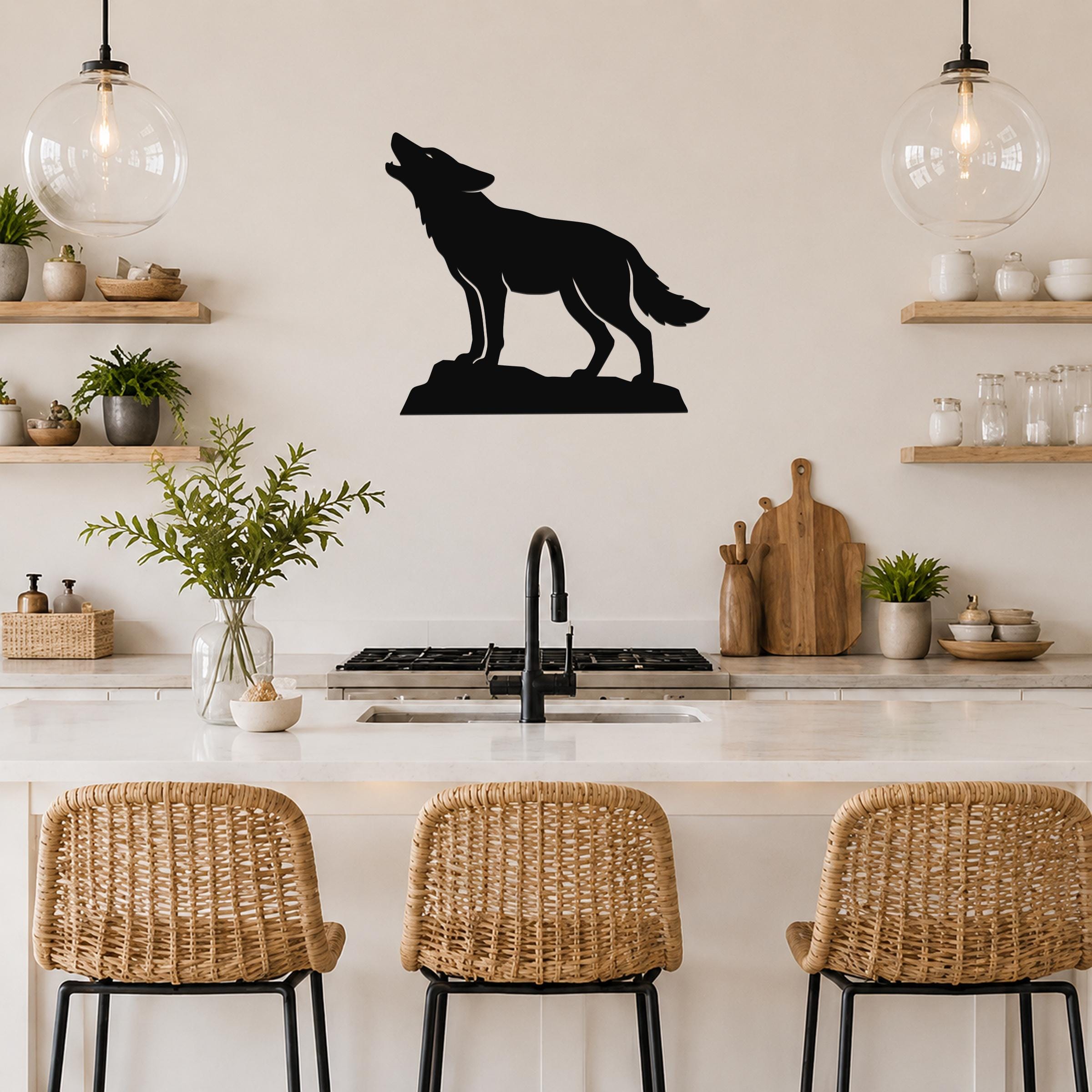 Black metal coyote wall art in a howling silhouette, mounted on a kitchen wall above a counter with wicker bar stools.