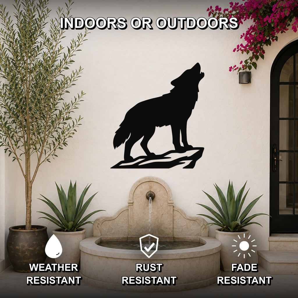 Black metal coyote wall art silhouette howling on a rock, mounted on an outdoor patio wall above a stone fountain, weather resistant, rust resistant, fade resistant.