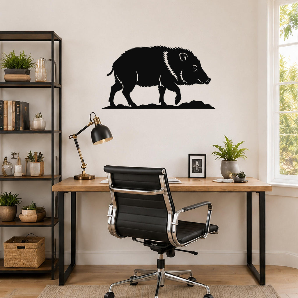 Black metal javelina wall art silhouette mounted above a wooden desk in a home office.