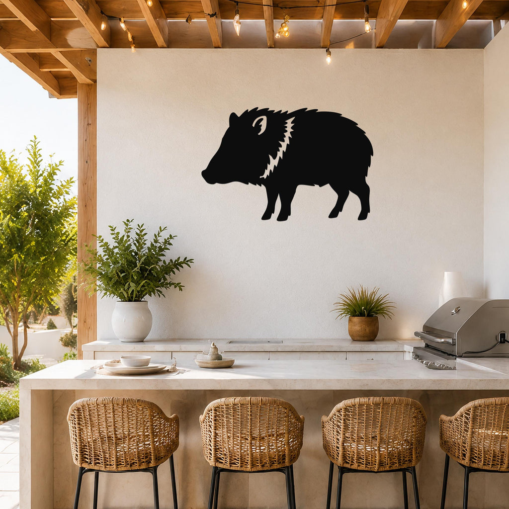 Black metal javelina wall art silhouette with white spiky mane detail, mounted on a white outdoor wall above a kitchen counter.