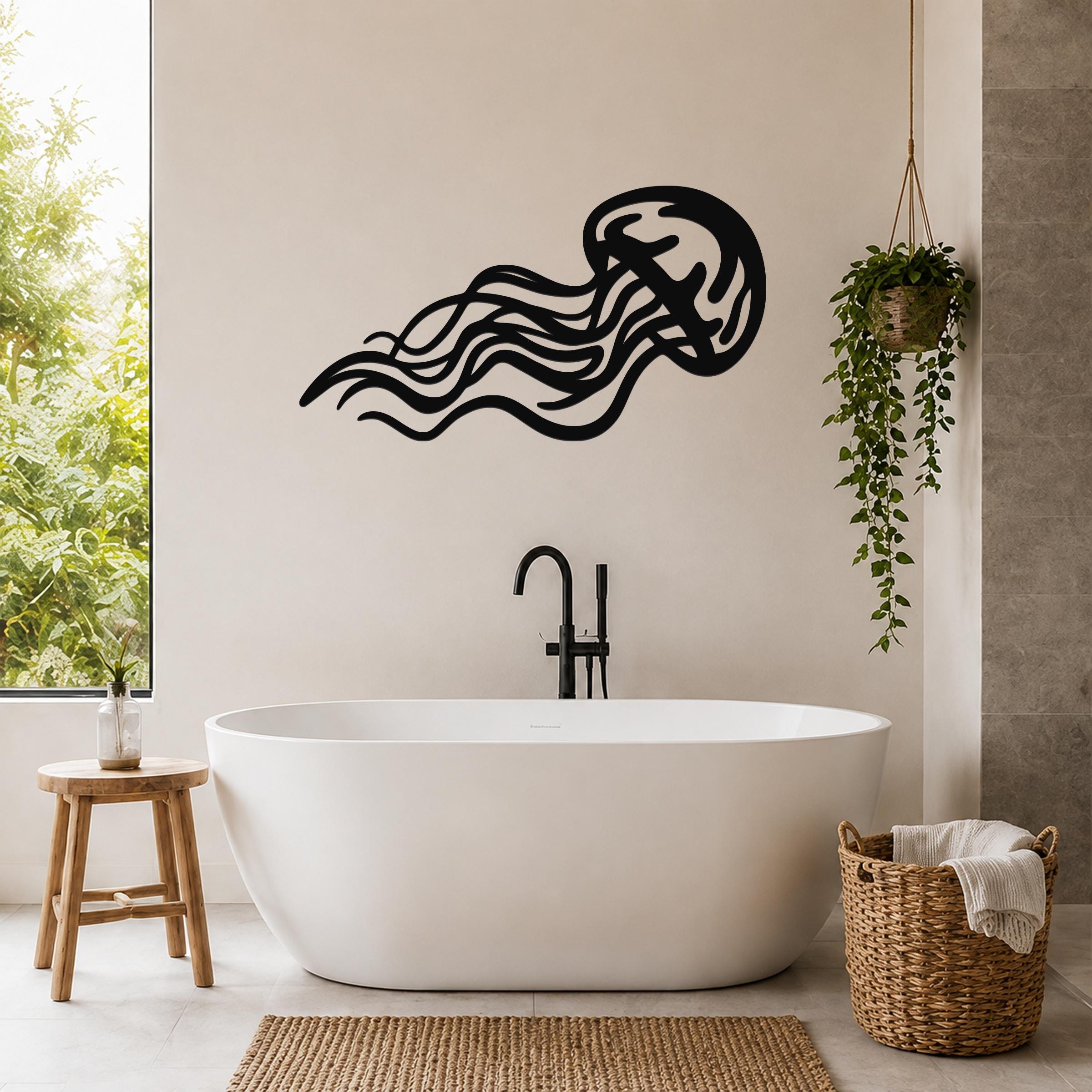 Black metal jellyfish wall art with flowing tentacle cutouts, mounted on a bathroom wall above a freestanding tub.