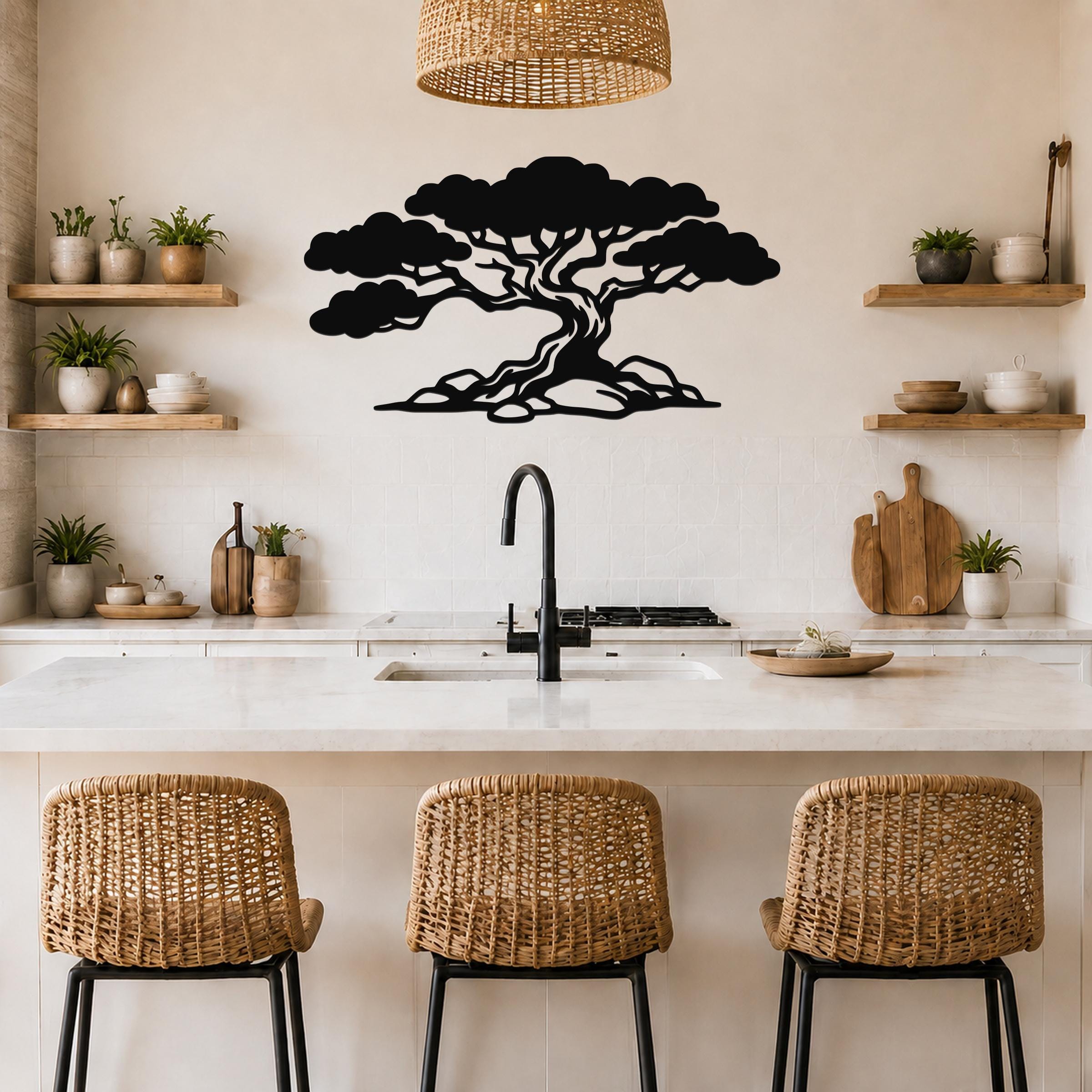 Black metal wall art of a wind-sculpted juniper tree silhouette, mounted on a kitchen wall above a counter with wicker bar stools.