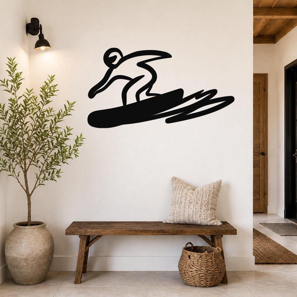 Black metal wall art silhouette of a snowboarder in motion, mounted on a white wall above a wooden bench in a modern entryway.
