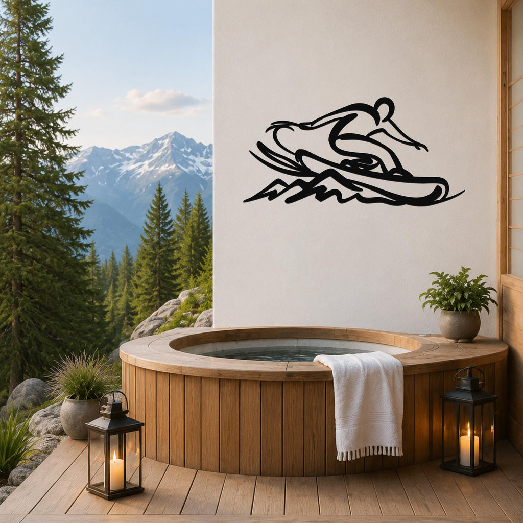Black metal wall art of a snowboarder silhouette with motion lines, mounted on a white wall above a wooden hot tub on a mountain-view deck.