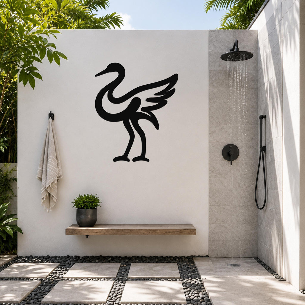 Black metal crane wall art in silhouette style, mounted on a white outdoor wall above a wooden bench in a modern shower area.