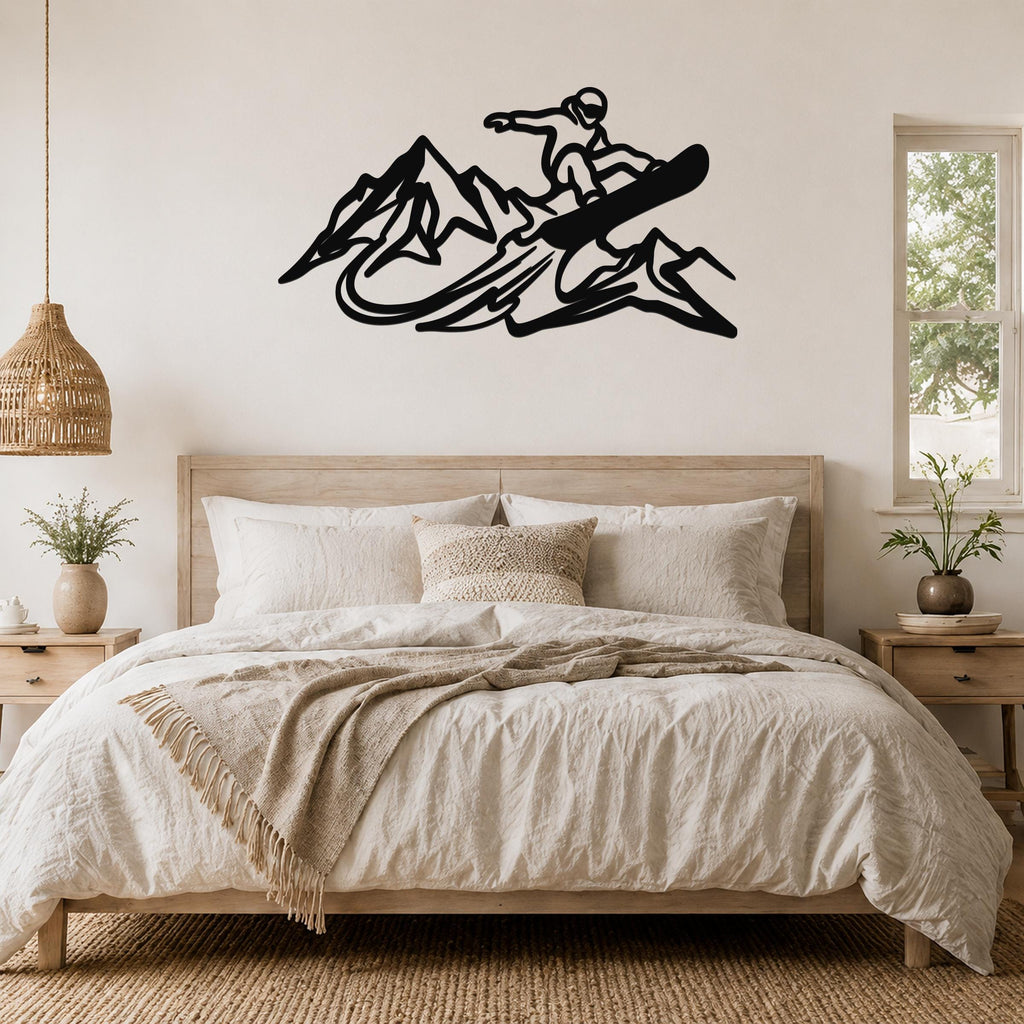 Black metal wall art featuring a snowboarder silhouette above a bed, mounted on a light-colored wall in a bedroom.