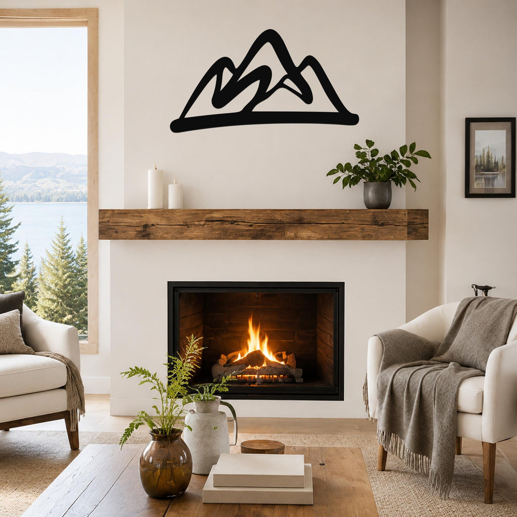 Black metal mountain silhouette wall art mounted above a fireplace in a living room with a lake view.