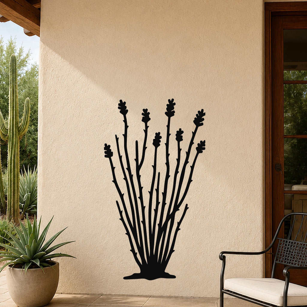 Black metal ocotillo wall art with branching stems and flower cutouts, mounted on a beige outdoor wall beside a potted plant and patio chair.