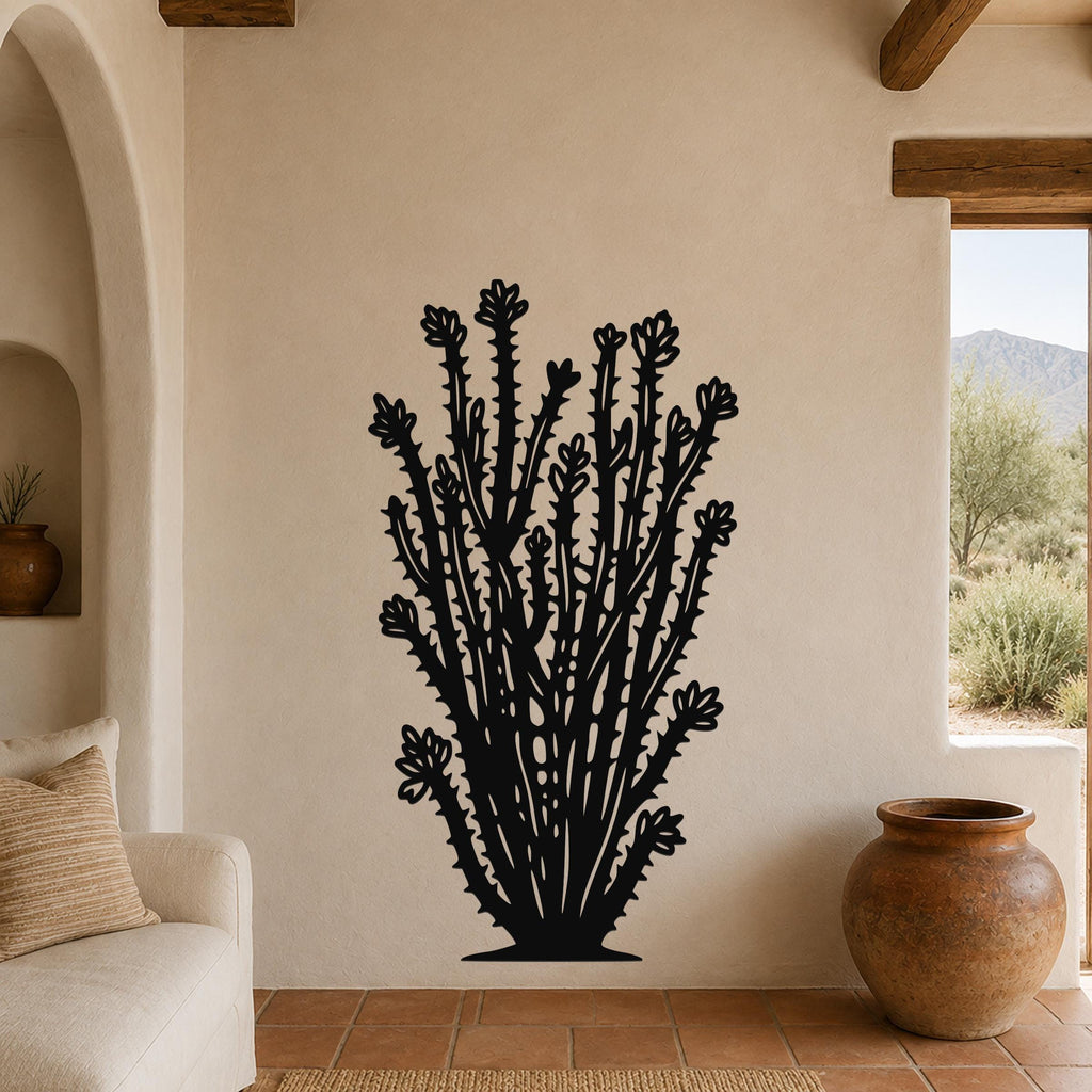 Black metal ocotillo wall art with detailed flower and spine cutouts, mounted on a beige living room wall above a sofa.