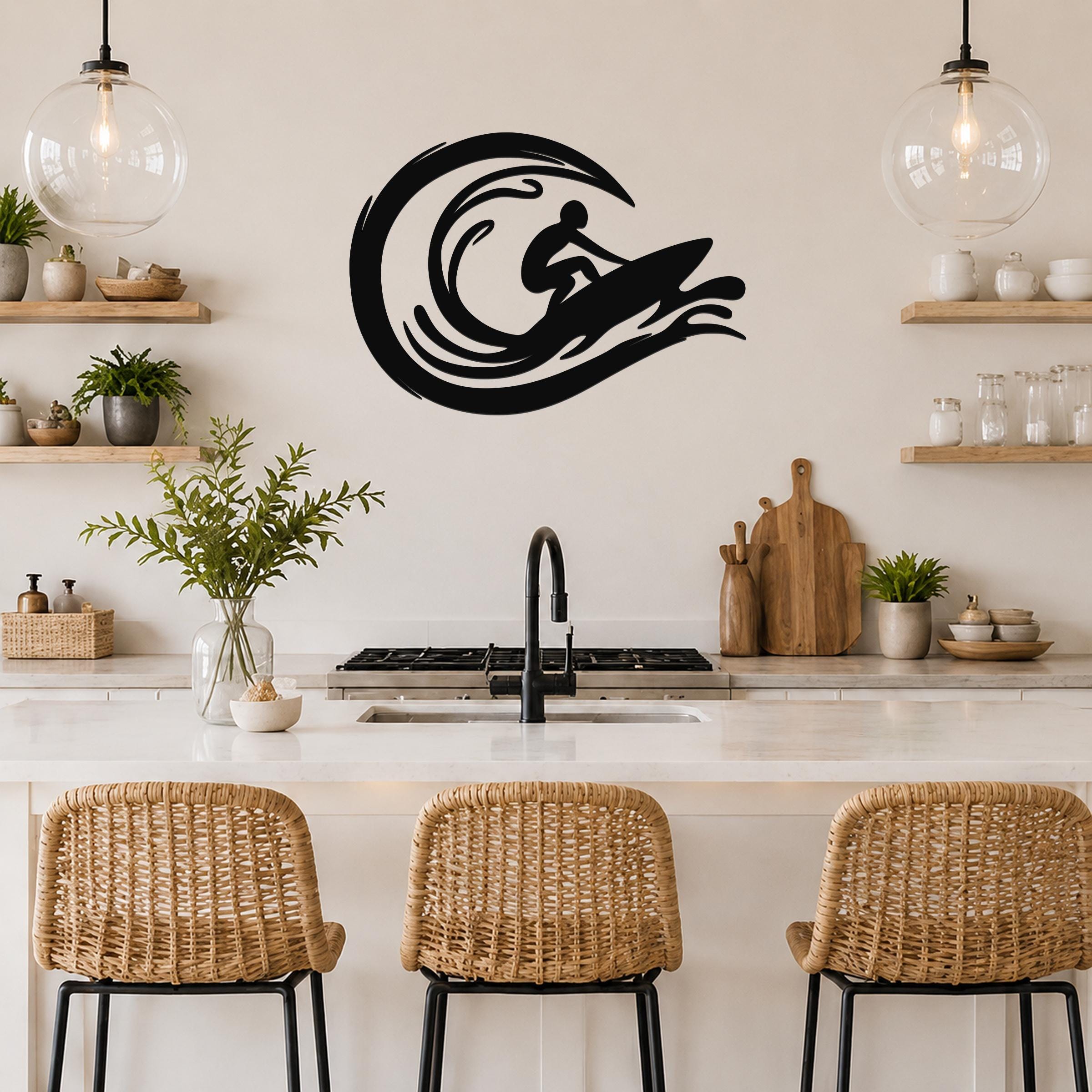 Black metal surfer wall art with wave cutouts, mounted above a kitchen counter in a coastal-style kitchen.