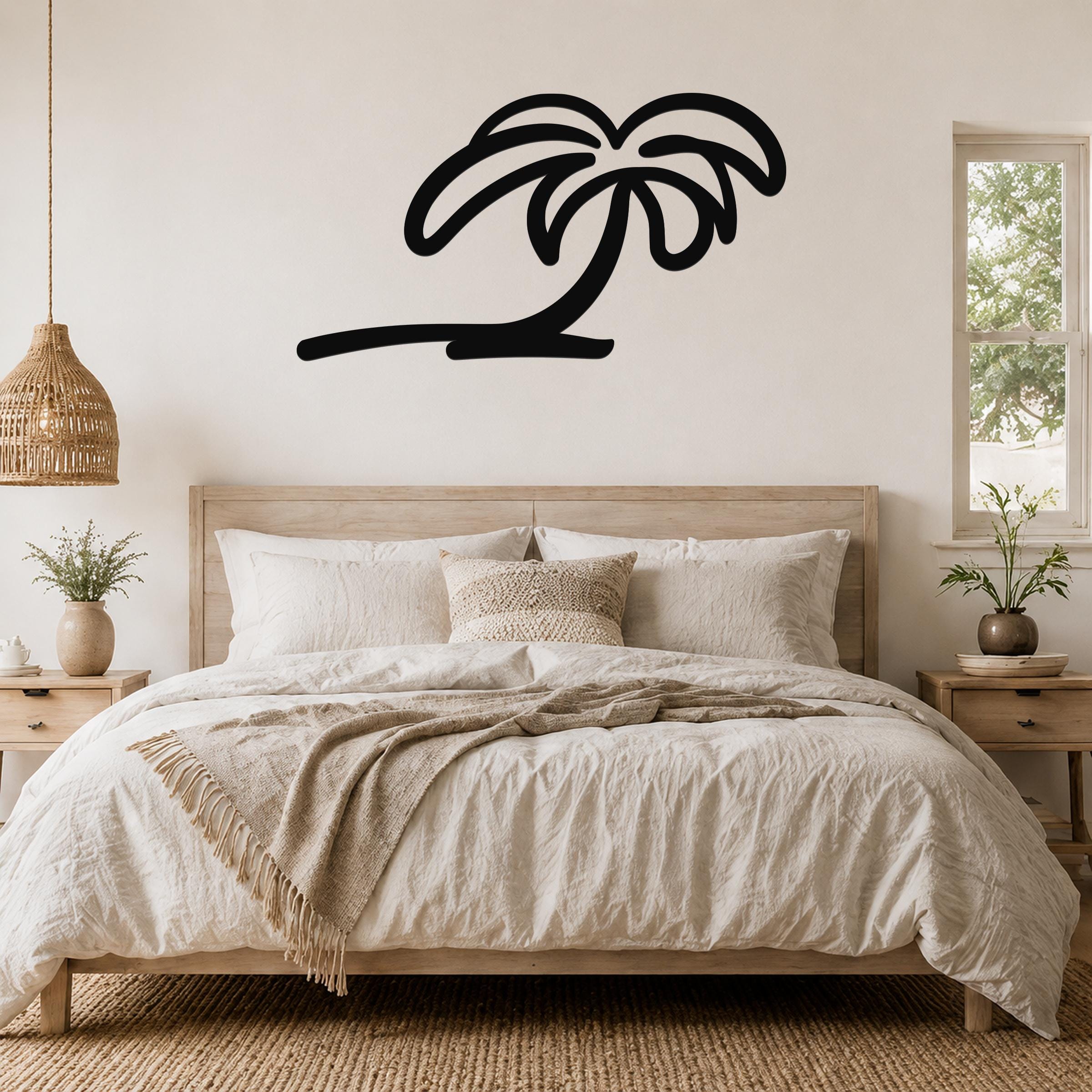 Black metal palm tree wall art with flowing frond cutouts, mounted above a wooden bed in a neutral bedroom.