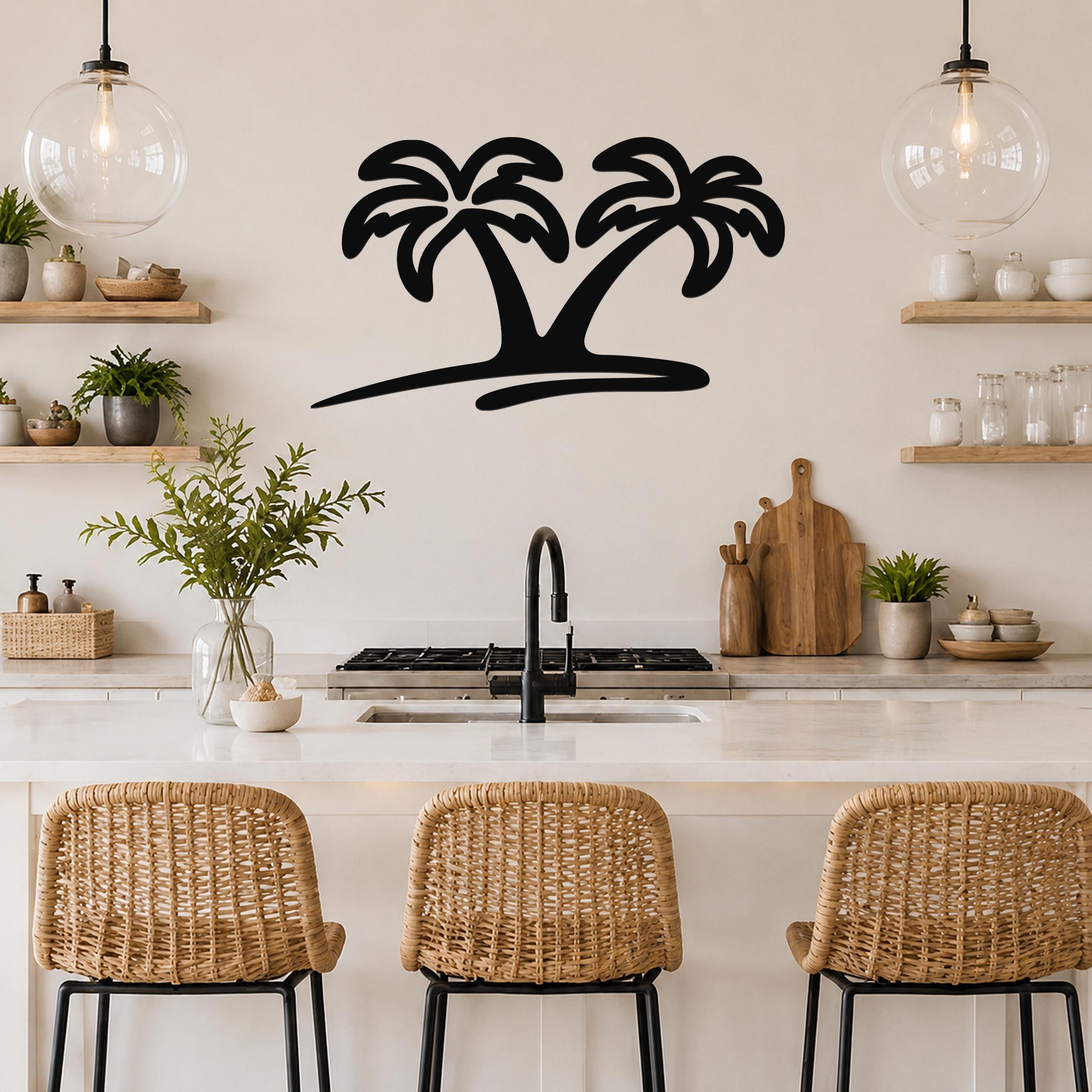 Black metal palm tree wall art with two silhouetted trees and a curved base, mounted on a kitchen wall above a counter.